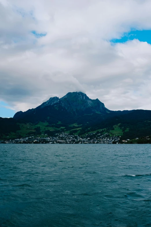 a large body of water with a mountain behind it