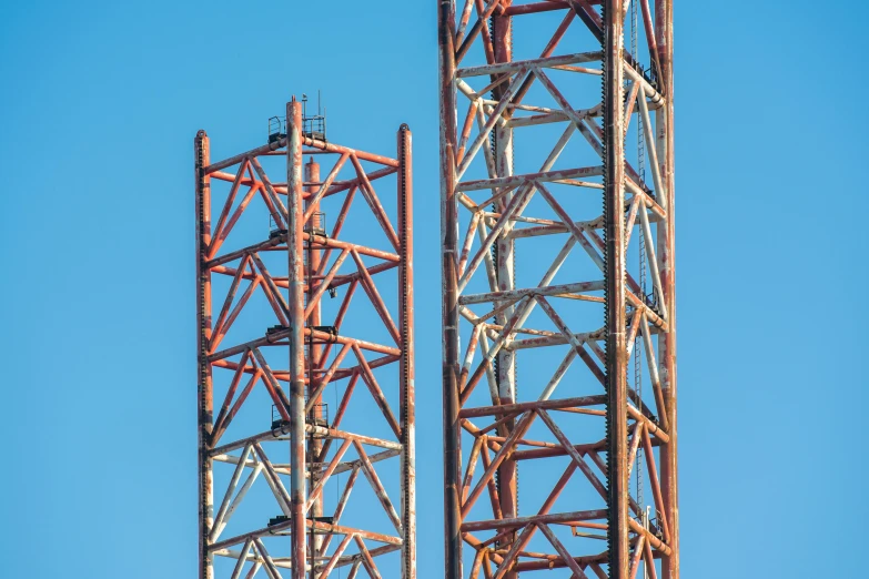 two towers one is made from metal and the other is made out of wood