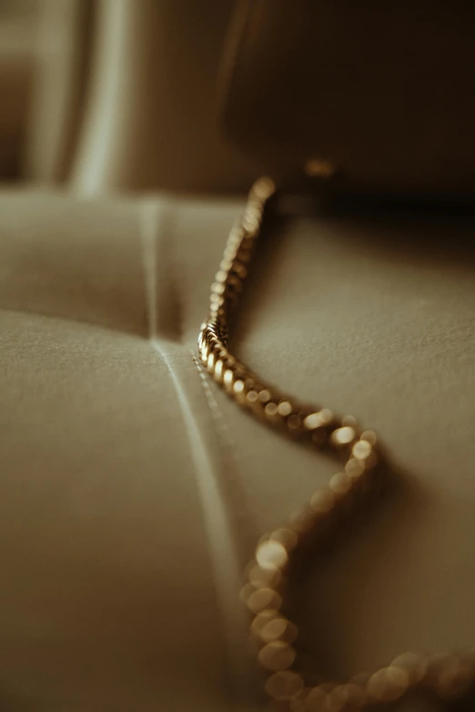 a necklace laying on a white surface