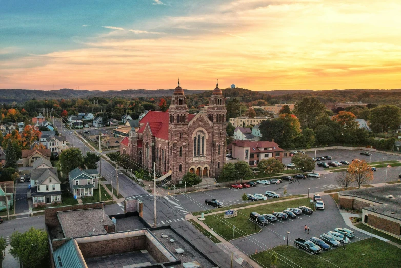 an aerial view of a city street in front of a sunset