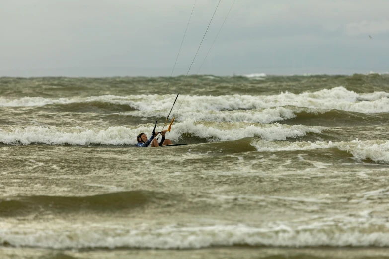 a person surfing and doing some tricks in the water