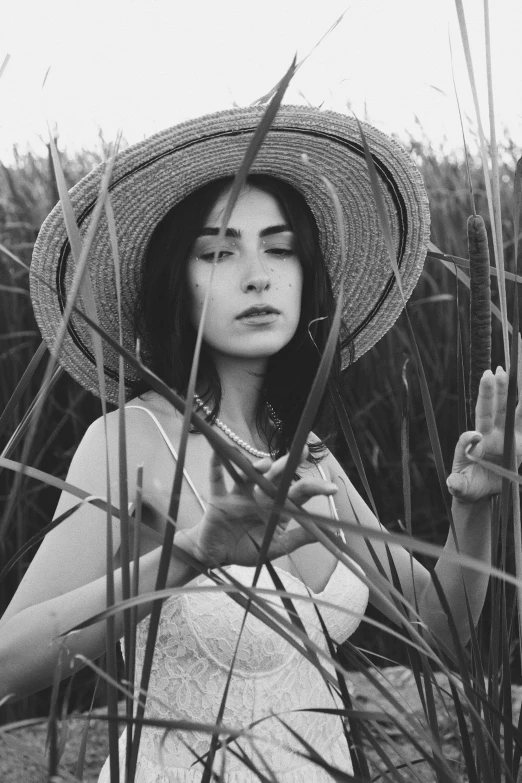 black and white pograph of a woman wearing a straw hat