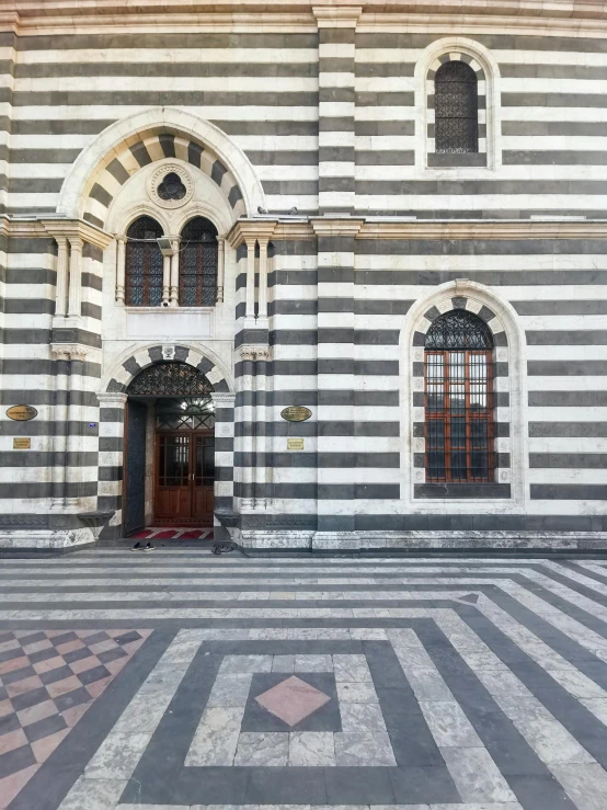 a black and white striped building with a clock