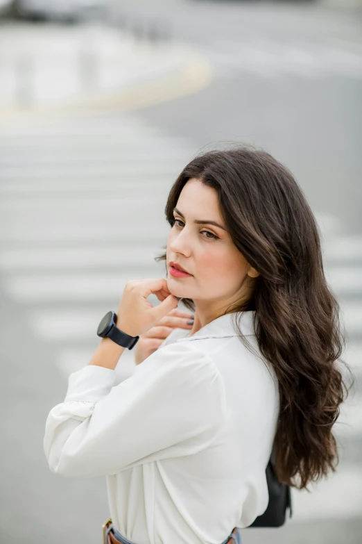 a woman holding a cell phone looking down and to the side