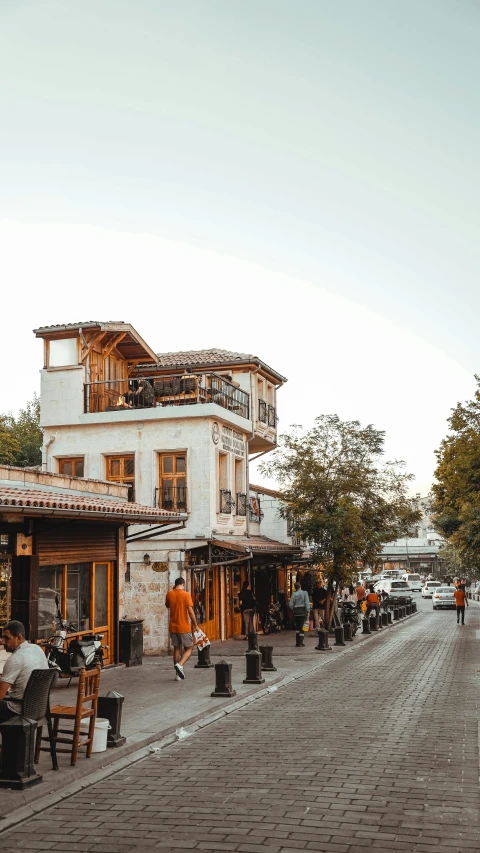 people sit around tables at an outdoor restaurant