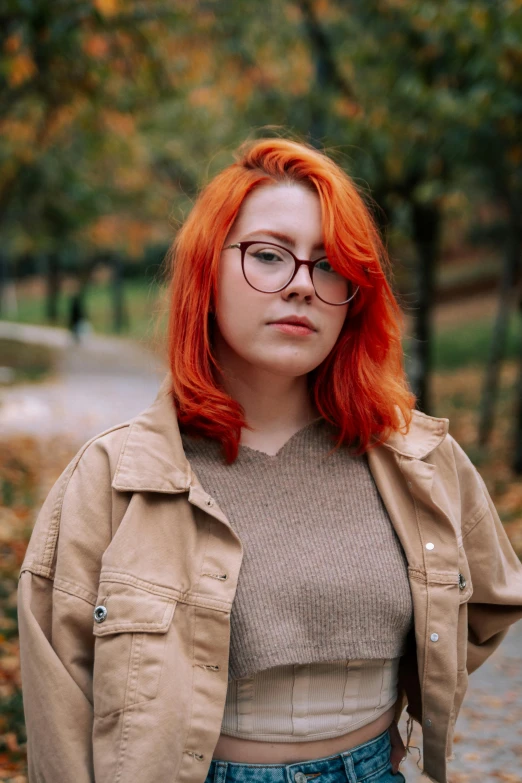 an orange headed woman with glasses in a park