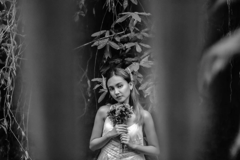 the bride is holding her bouquet in a po