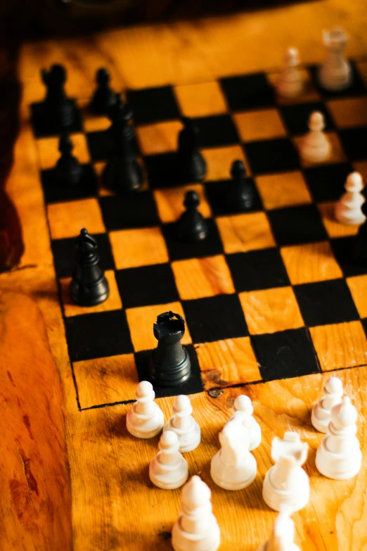 a wooden chess board and some white pawns