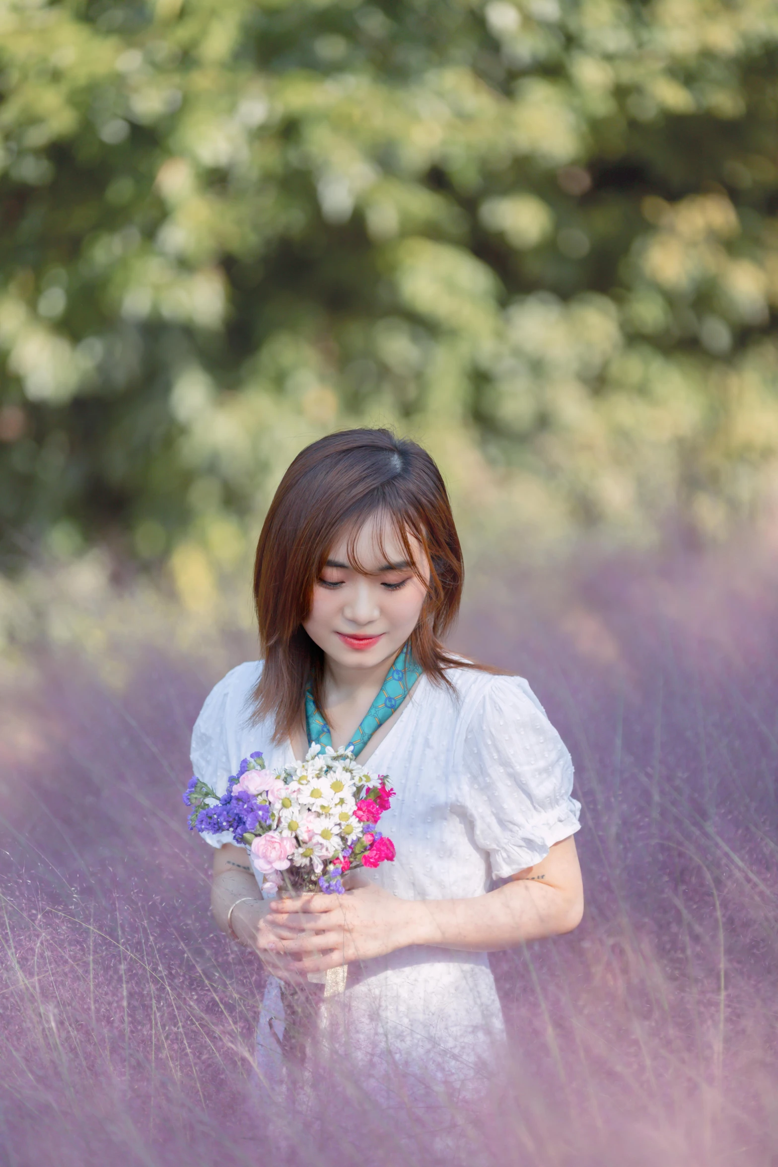 a girl holding flowers in a field