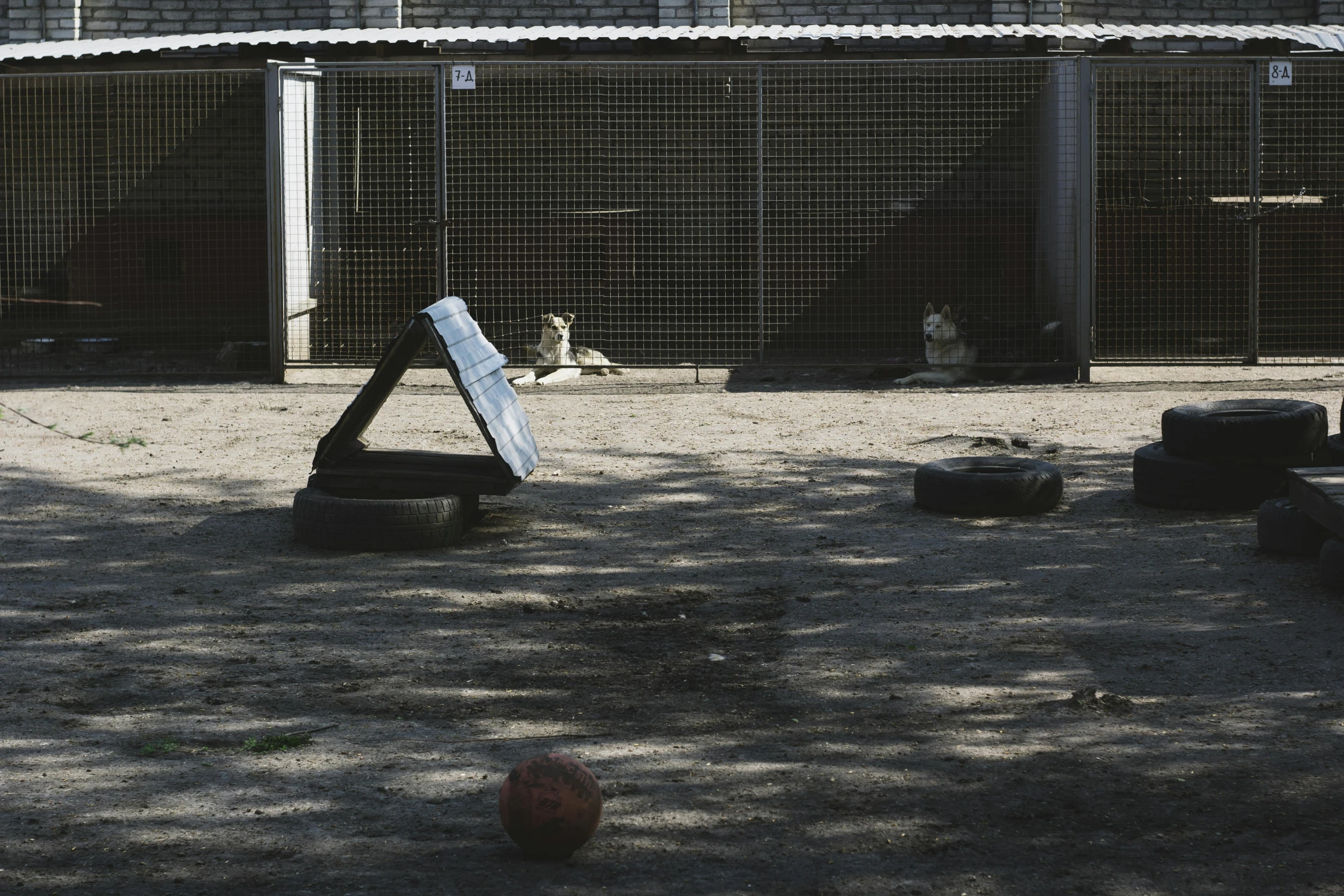 the enclosure has items like a tire track and a sign on it