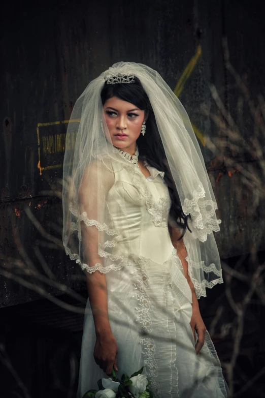 a beautiful young bride standing next to the barn