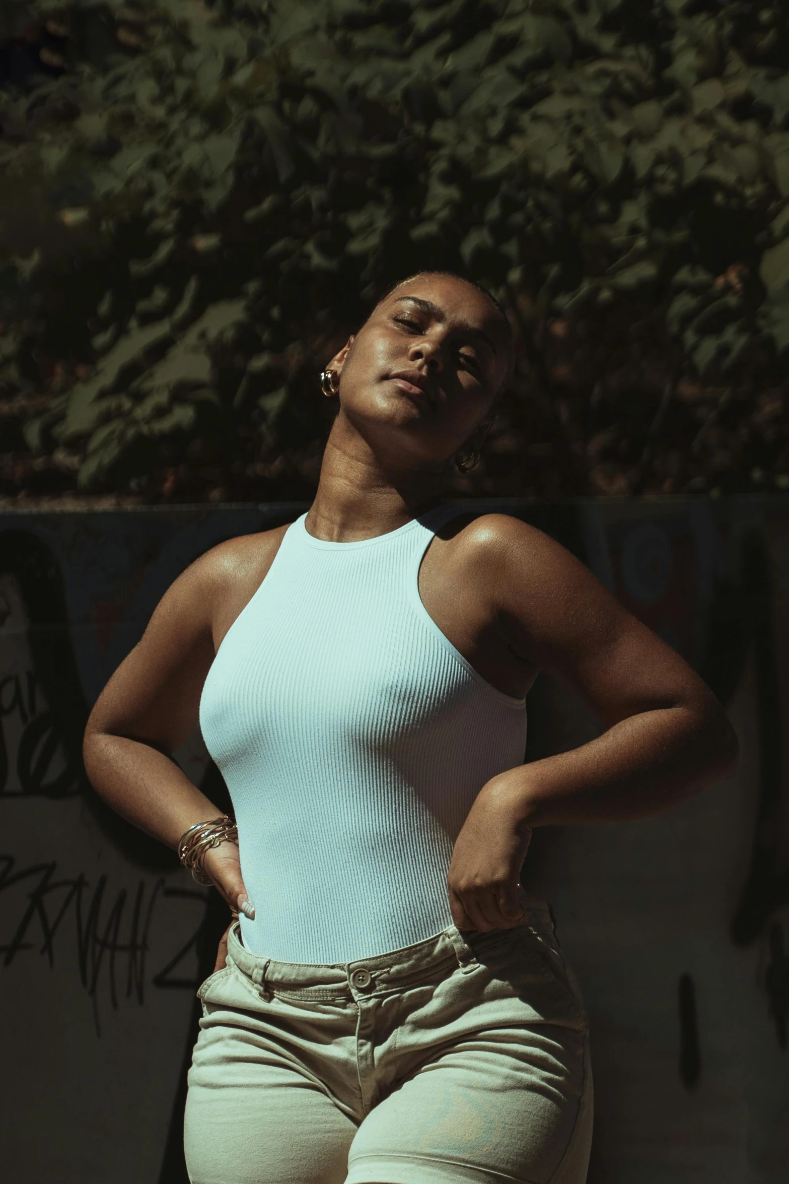 a young african american woman leaning against a wall