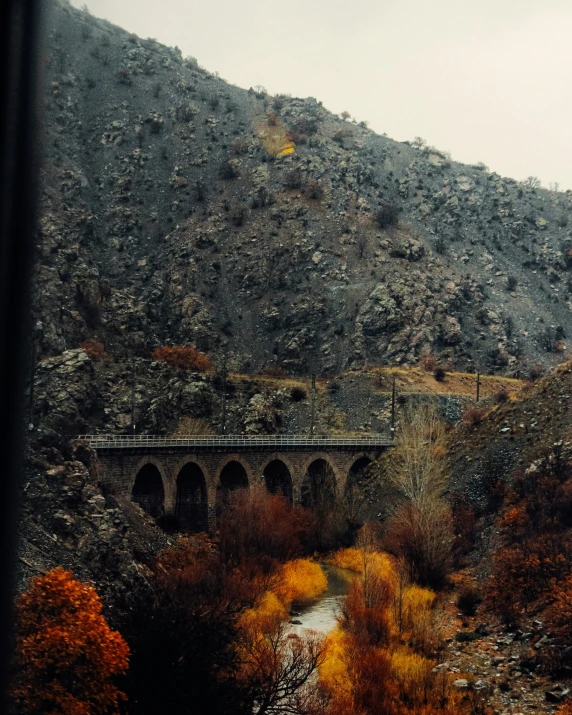 a bridge that is in the middle of some mountains