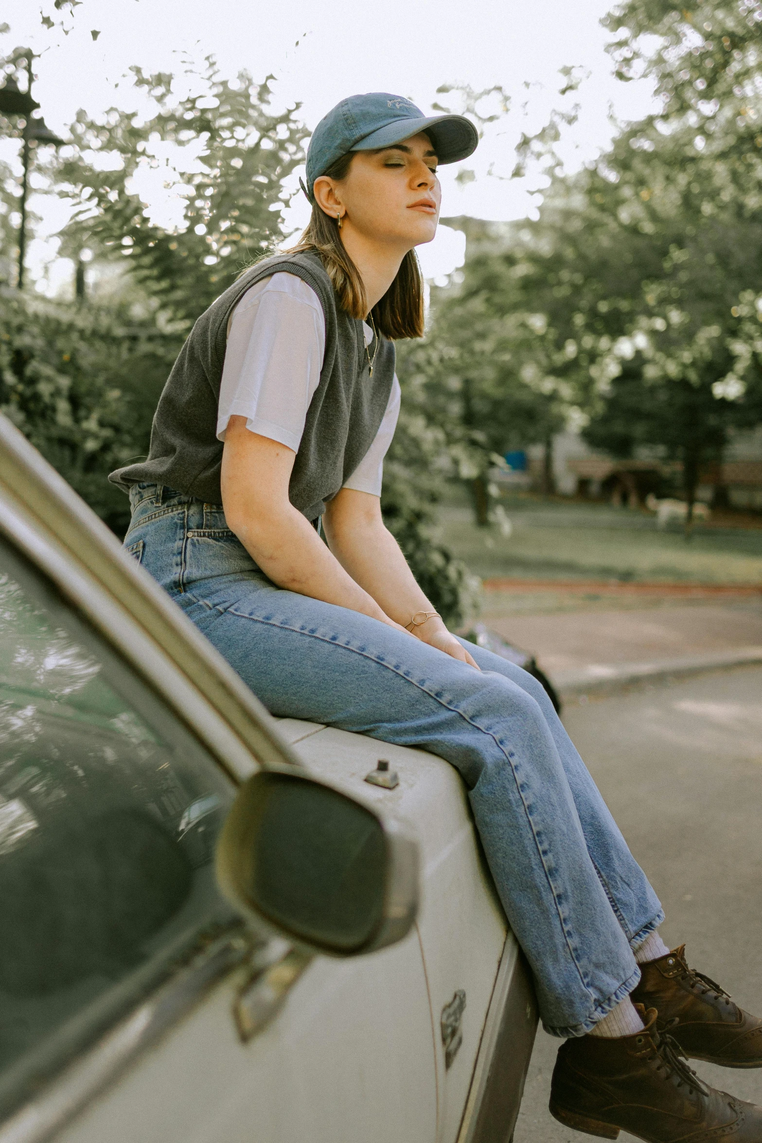 a woman sitting on the back of a car
