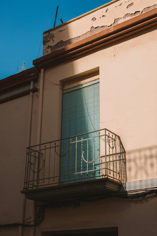 the side of an old building with a round window