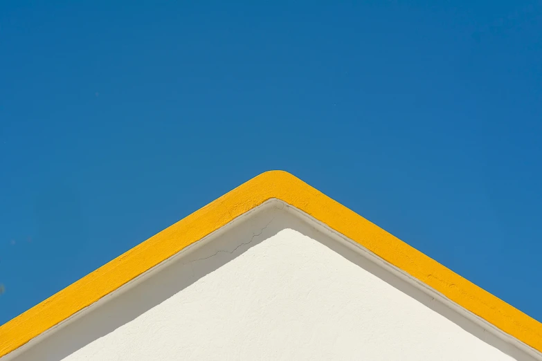 a view of the top of a building's roof with an airplane in the sky