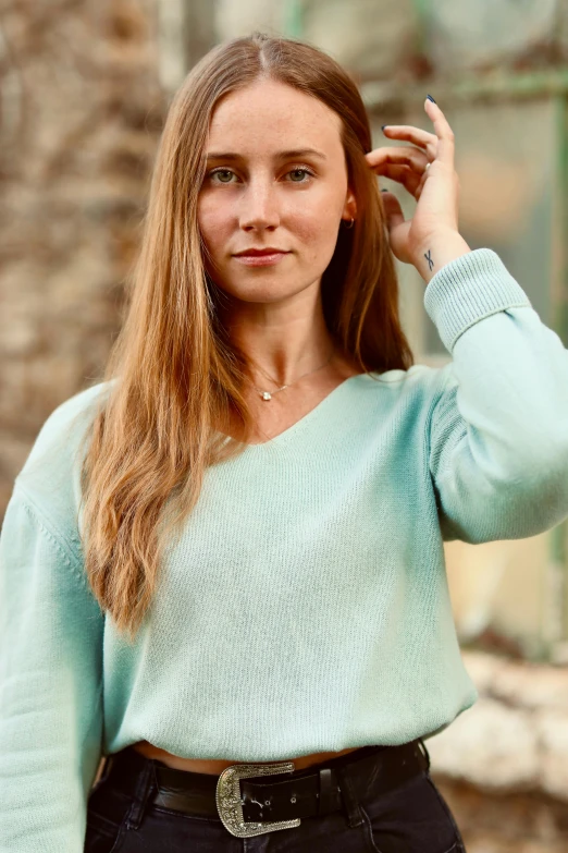 a woman with long hair is posing for the camera