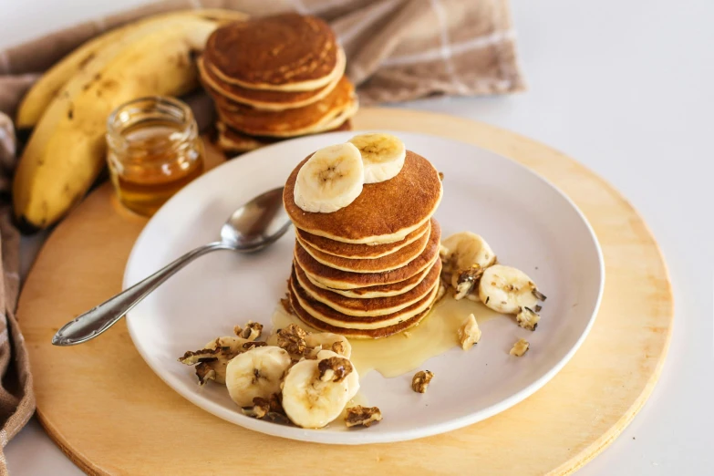a plate with bananas, pancakes and nuts