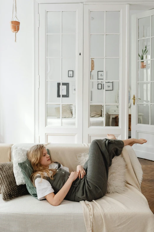 a woman lying on the back of a couch