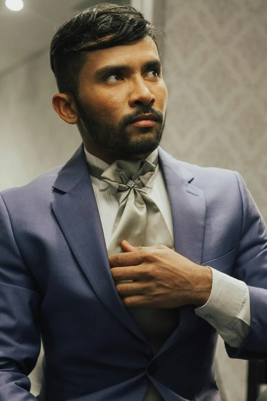 an indian man in suit and tie standing