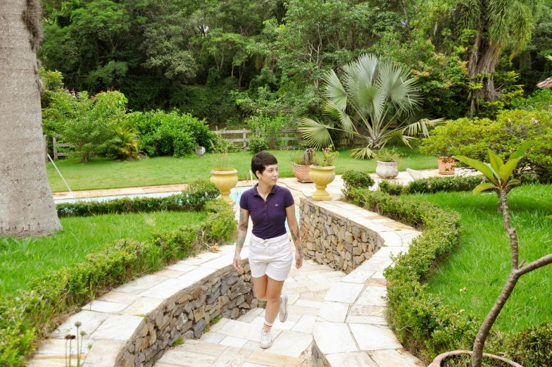 a woman walking up the steps in front of her home