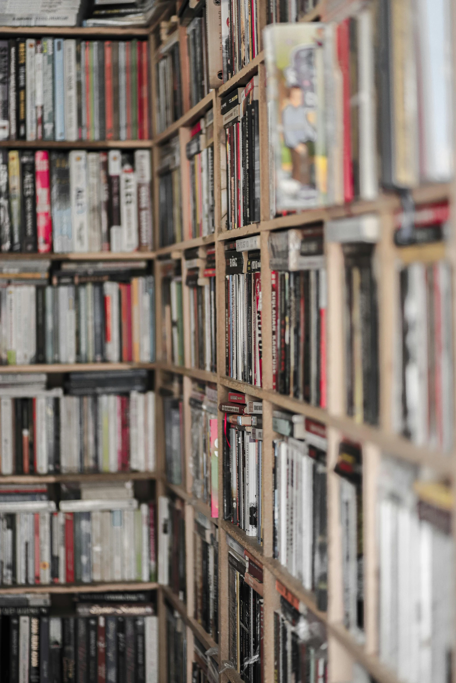 a book case full of lots of books and dvds