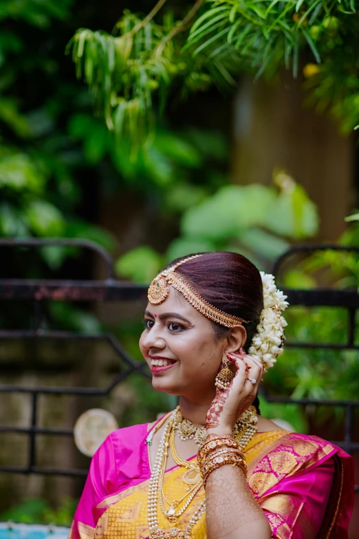 a woman wearing an indian outfit in her hands