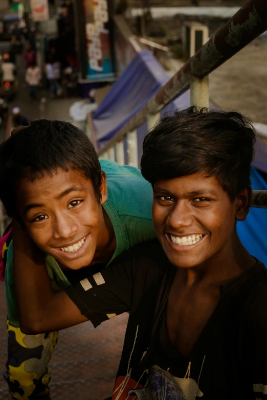 two boys with heads wrapped around each other