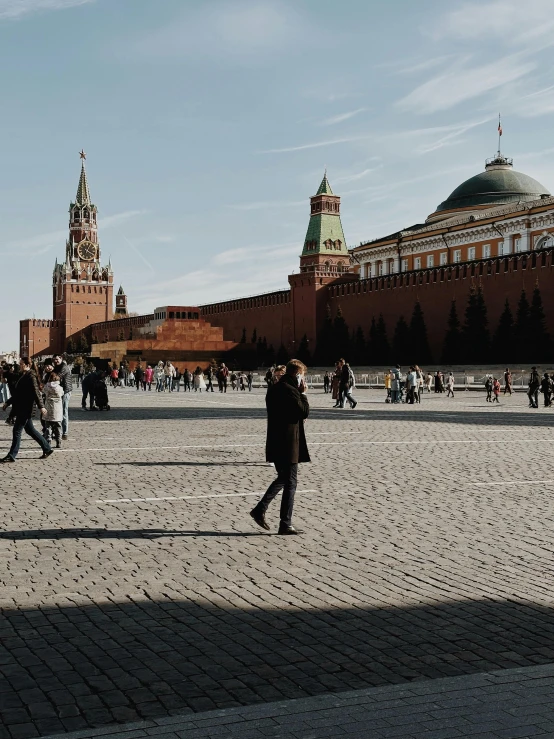 people walking across the square in a big city