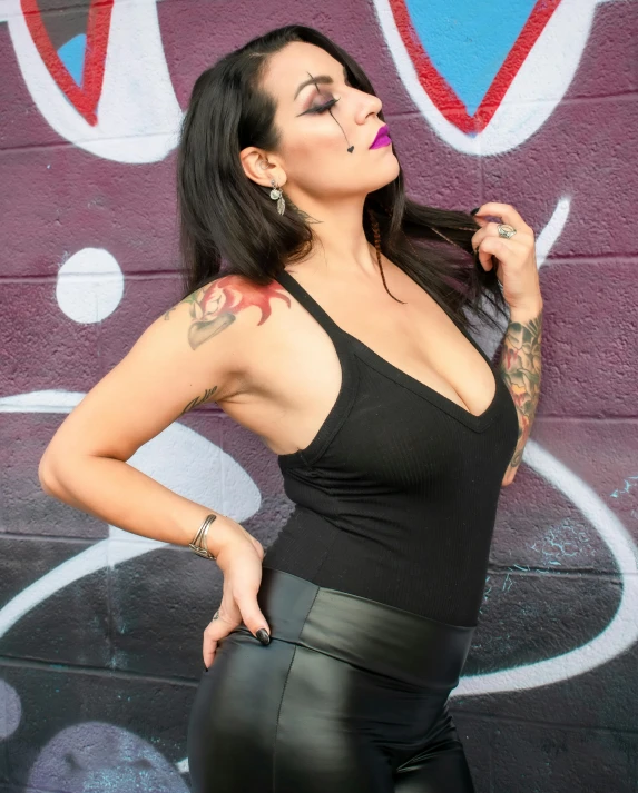 a woman with a tattoo wearing black underwear and tattoos