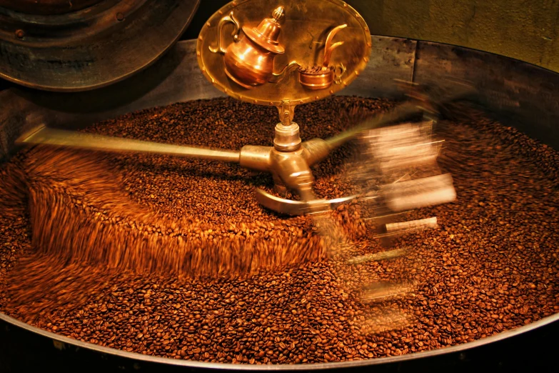 a bucket of oil, which is filled with coffee beans