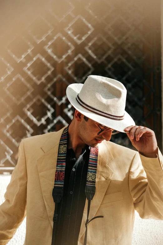 a man wearing a straw hat and scarf