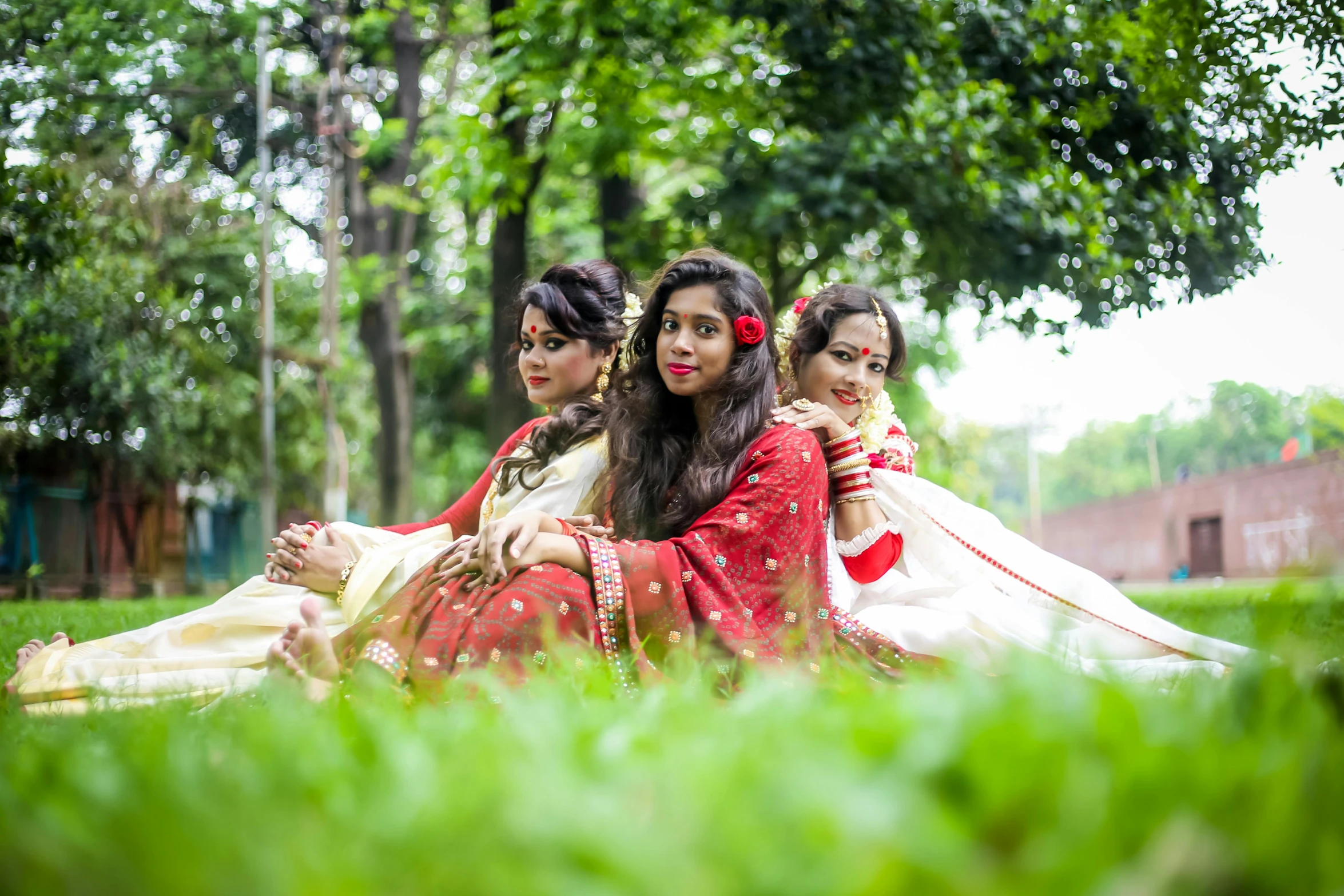 three women in dress are relaxing and posing for the camera