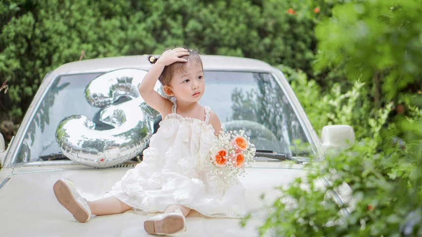 a  sitting on the hood of a white truck