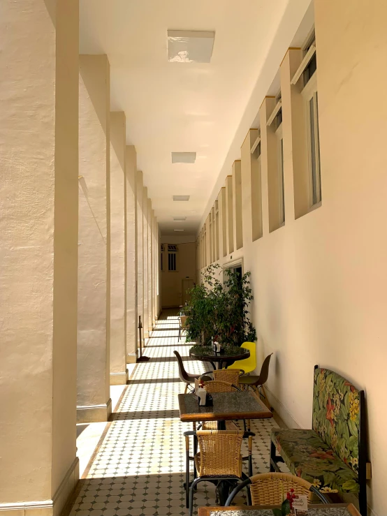 a hallway with a bunch of tables and benches