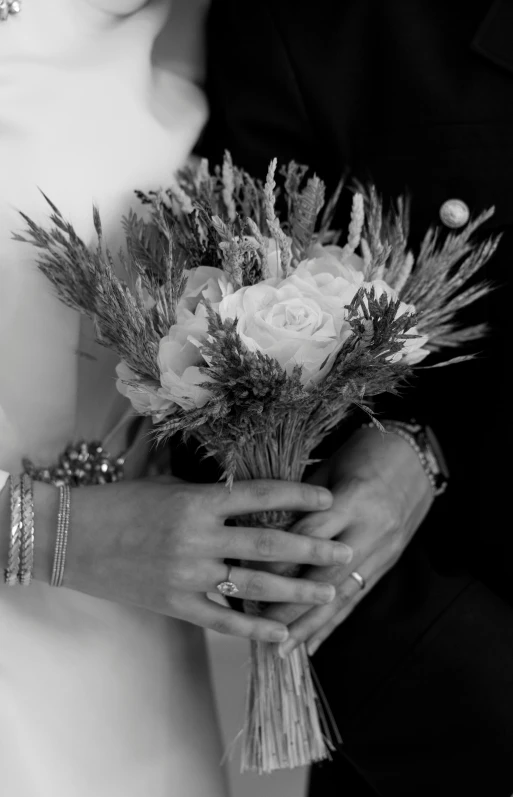 two people holding flowers are standing