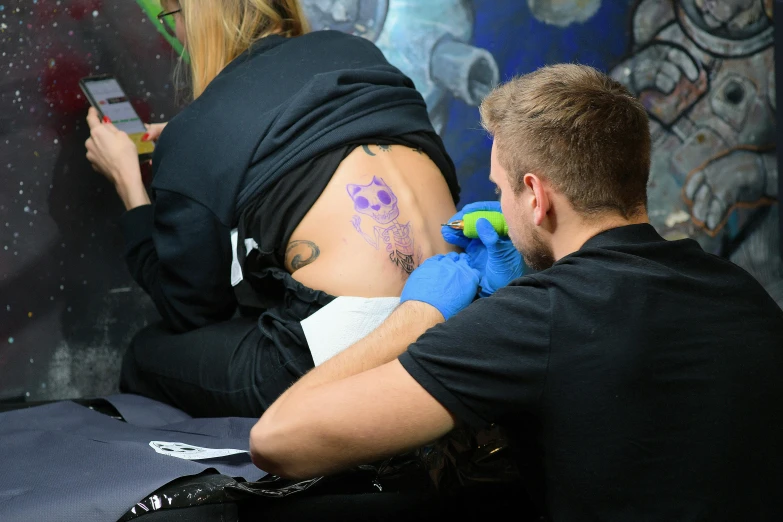 the tattooed arm of a man with a blue hand