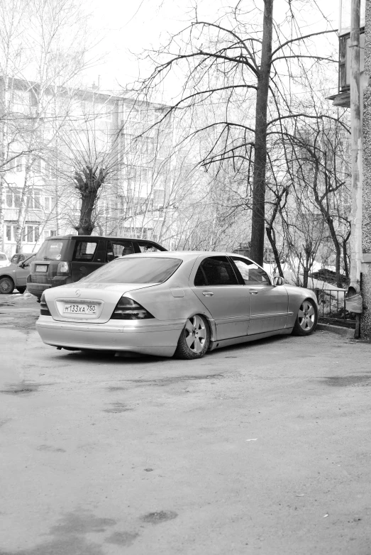 the car is parked near two other cars