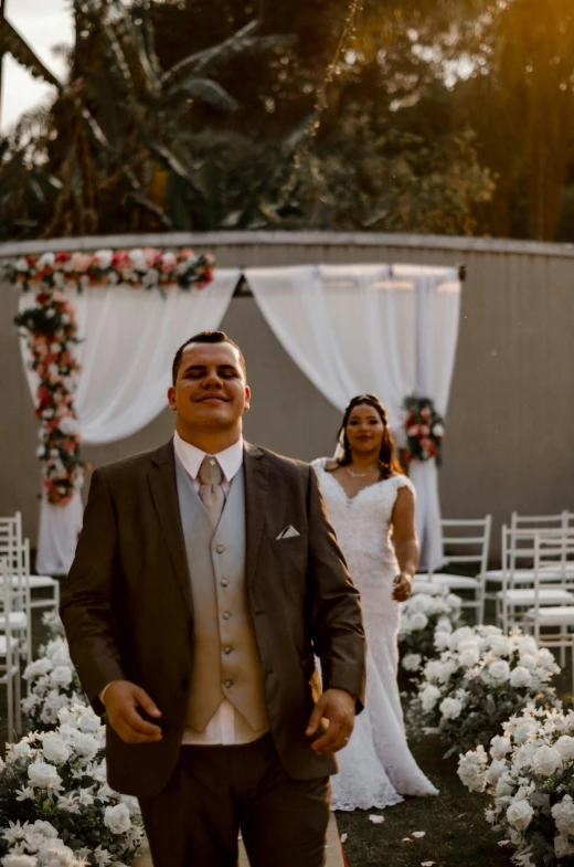 a bride and groom walking into their wedding ceremony