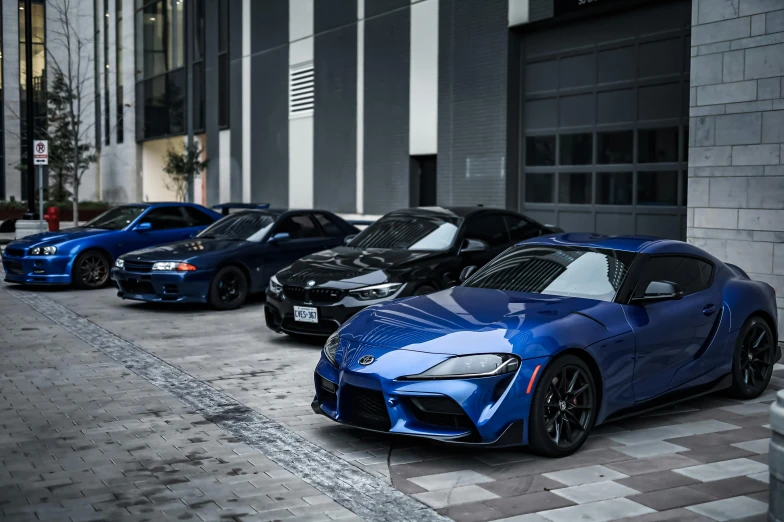 three different types of cars are parked outside of a building