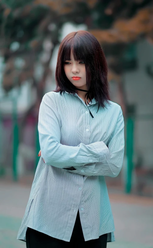 a woman with long black hair wearing a suit