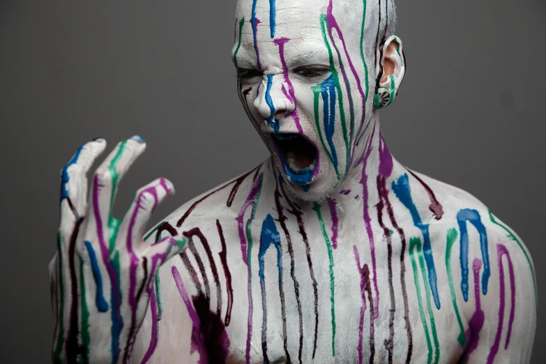 a body painted with different colored lines and dripping paint