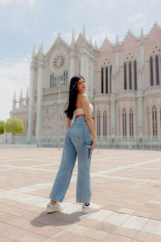 a woman is standing with her legs crossed