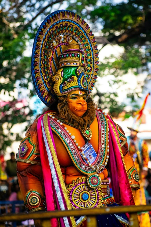 an artistic looking man wearing colorful headdress at the thai festival