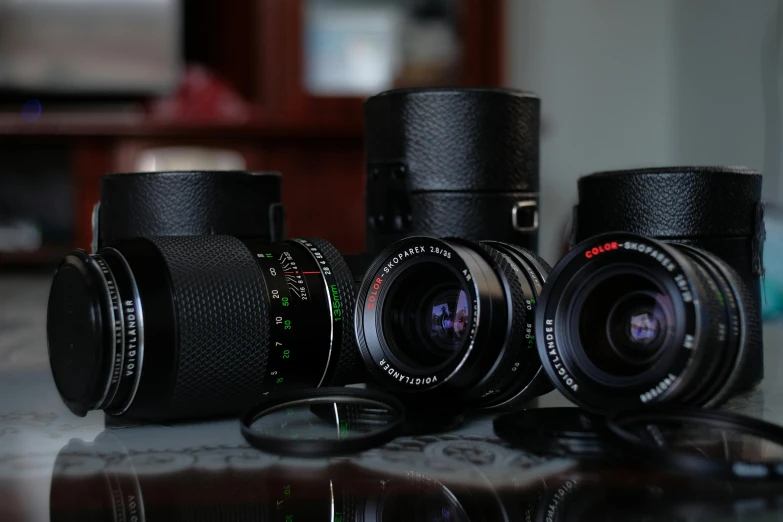 three different camera lens sitting next to each other on a counter