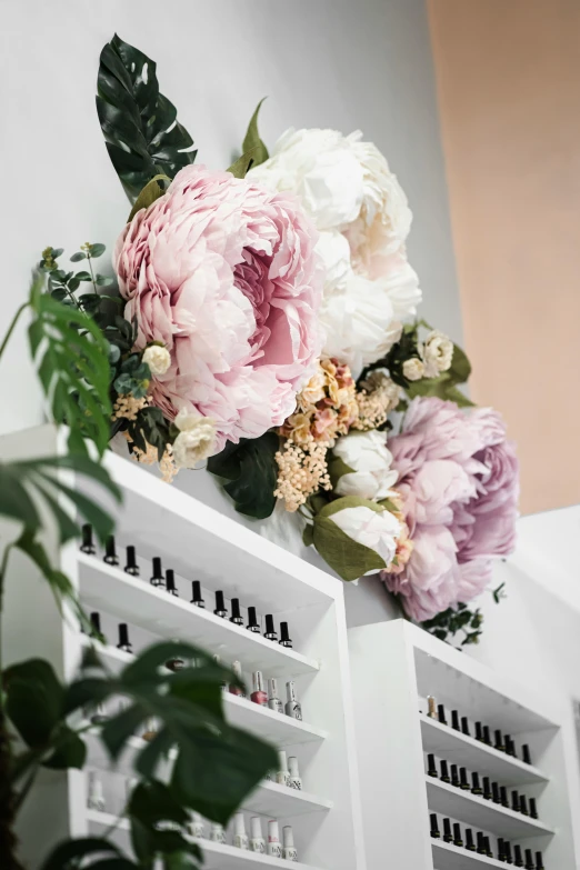 there is a large flower bouquet sitting on top of the shelves