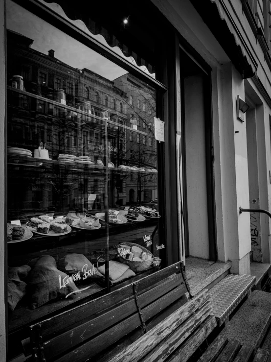 black and white image of a bakery window