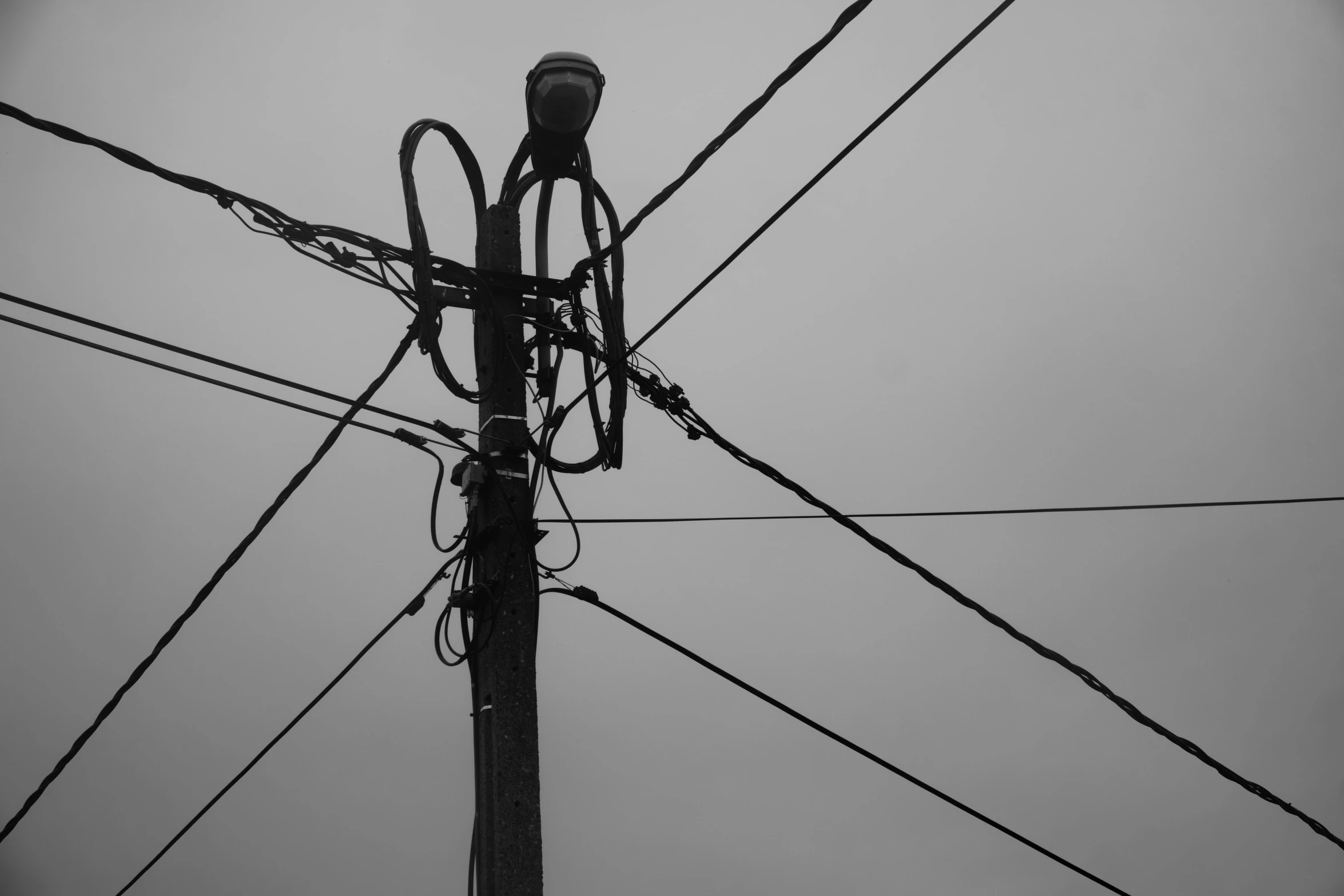 the top of some power poles and wires