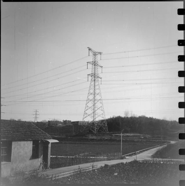 black and white pograph of power lines above a hill