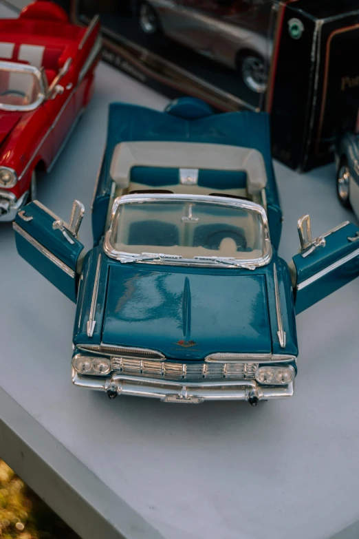 a model car and other toy cars on a table